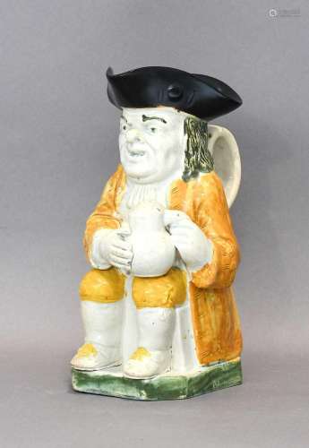 A Prattware Toby Jug, early 19th century, modelled holding a...