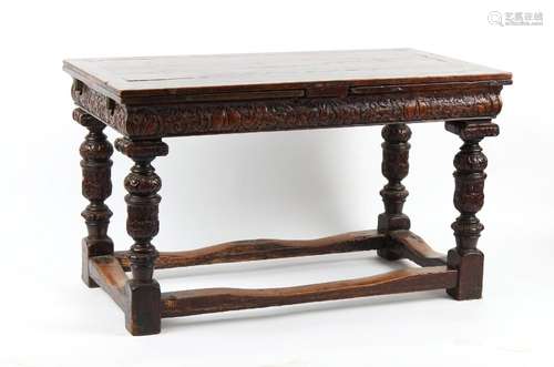 Property of a gentleman - a carved oak draw-leaf dining tabl...