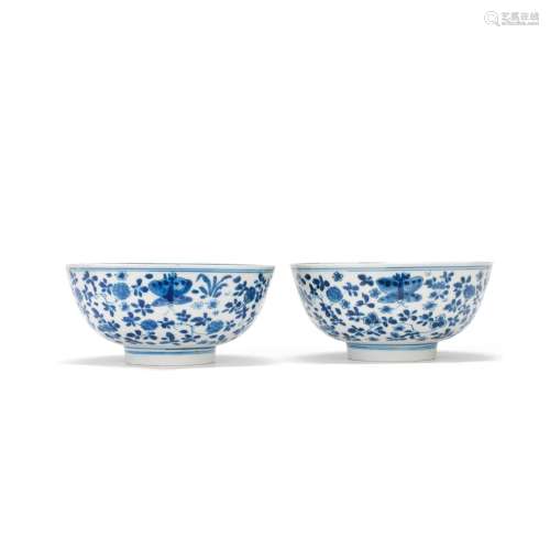 A PAIR OF BLUE AND WHITE FLORAL BOWLS Kangxi six-character m...