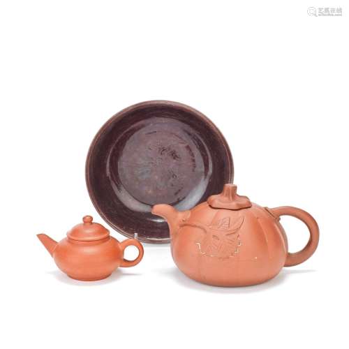 AN AUBERGINE GLAZED 'LOTUS' BOWL AND TWO YIXING TEAPOTS AND ...