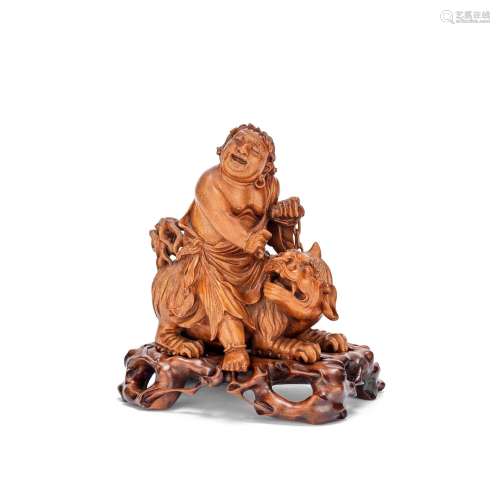 A LONGAN WOOD CARVING OF A FIGURE RIDING A LUDUAN Late Qing ...