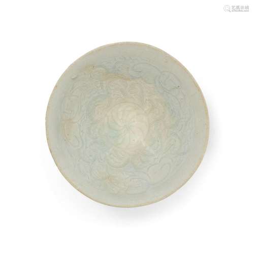 A Chinese qingbai-glazed carved 'lotus and boys' bowl<br />
...