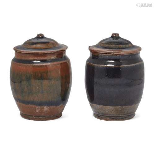 A pair of Chinese Henan black and russet-glazed jars and cov...