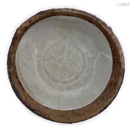 A Chinese qingbai-glazed 'waster' bowl in a saggar<br />
<br...