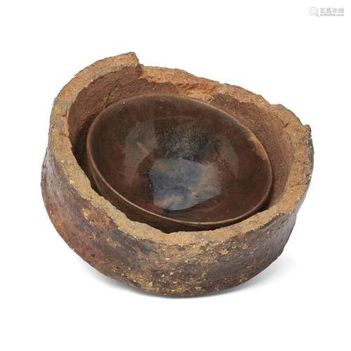 A Henan black-glazed 'hare's fur' teabowl in a saggar<br />
...