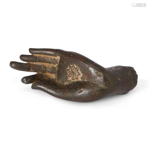 A Tibetan or Nepalese bronze hand of a Buddhist figure<br />...