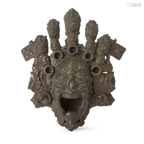 A Tibetan bronze head of a wrathful deity<br />
<br />
19th ...