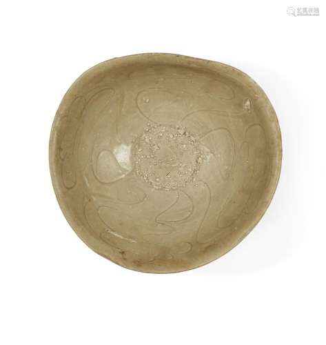 A Chinese incised celadon-glazed stoneware bowl<br />
<br />...