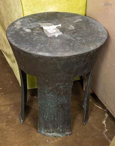 An Asian style patinated metal drum table