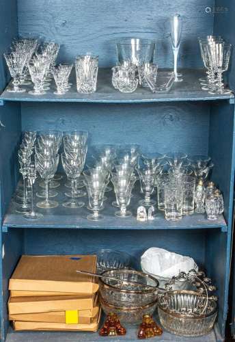 Three shelves of crystal stemware and pressed glass bowls, i...