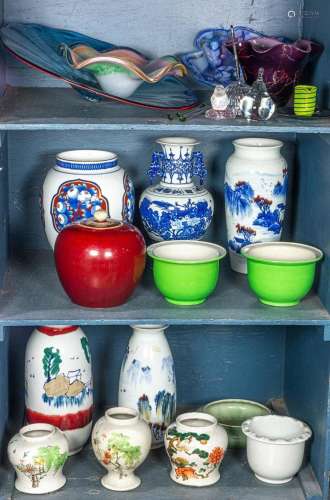 Two shelves of mostly Chinese ceramic vases and planters tog...