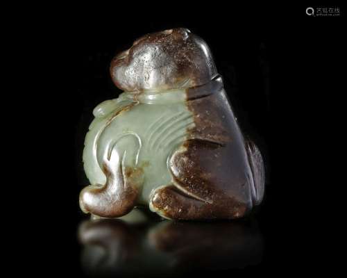 A CHINESE SPINACH CARVED JADE FU DOG, MING DYNASTY (1368-164...