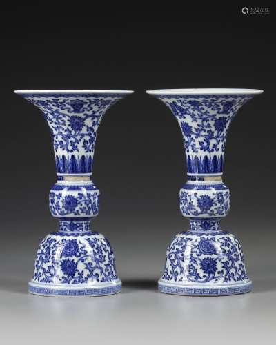 A PAIR OF CHINESE BLUE AND WHITE GU-FORM ALTAR VASES, QING D...