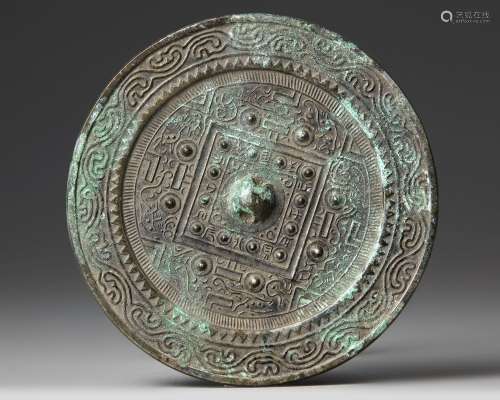 A CHINESE CIRCULAR 'TLV' BRONZE MIRROR,  XIN/EARLY EASTERN H...