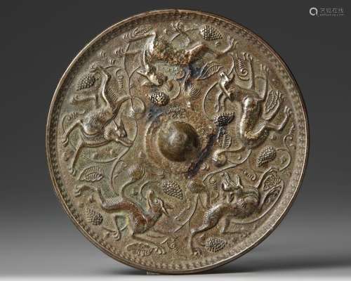 A CHINESE BRONZE CIRCULAR MIRROR WITH ANIMALS, SONG DYNASTY ...