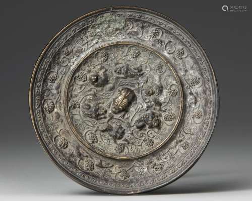 A CHINESE CIRCULAR "LIONS AND BIRDS" BRONZE MIRROR...