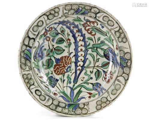 AN IZNIK POTTERY DISH WITH QUATRE FLEURS DECORATION, OTTOMAN...