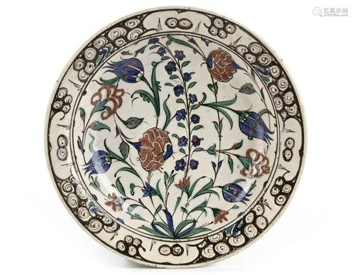 AN IZNIK 'STORM IN A TEACUP' DESIGN POTTERY DISH, TURKEY, 16...