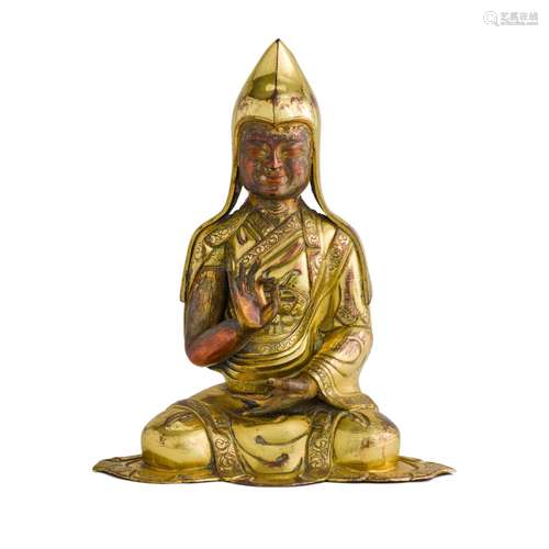 A gilt-bronze and repoussé figure of a lama, Qing dynasty, 1...