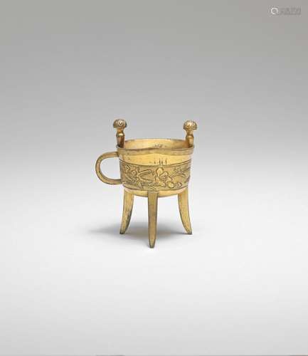 AN ARCHAISTIC GILT-BRONZE RITUAL TRIPOD WINE VESSEL, JUE  18...