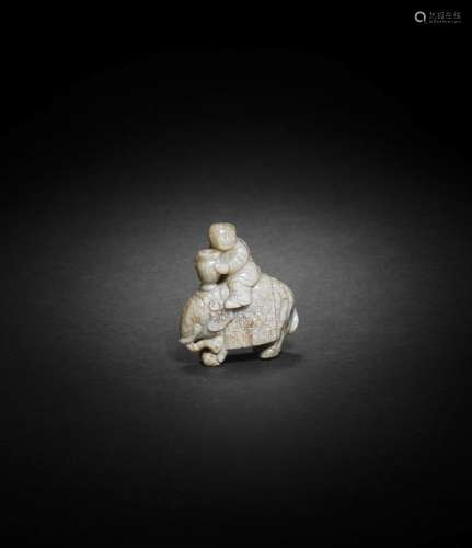 A 'CHICKEN BONE' JADE GROUP OF A BOY, ELEPHANT AND VASE Ming...