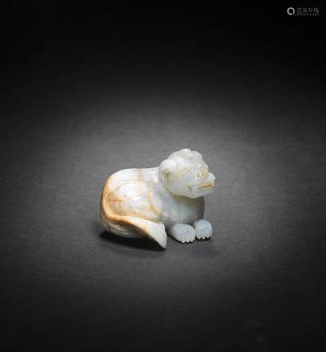 A PALE GREEN AND RUSSET JADE CARVING OF A MYTHICAL BEAST Min...