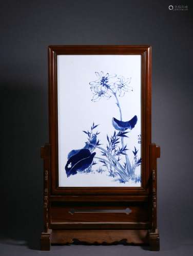 A blue and white flower and bird plaque