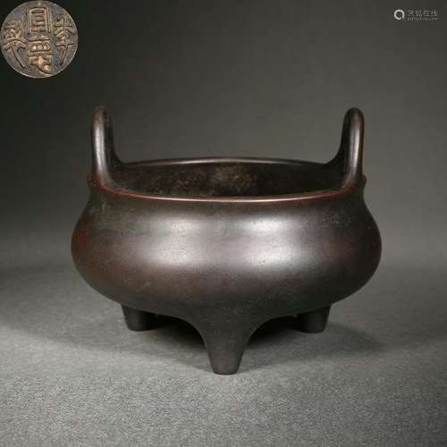 A bronze tripod censer