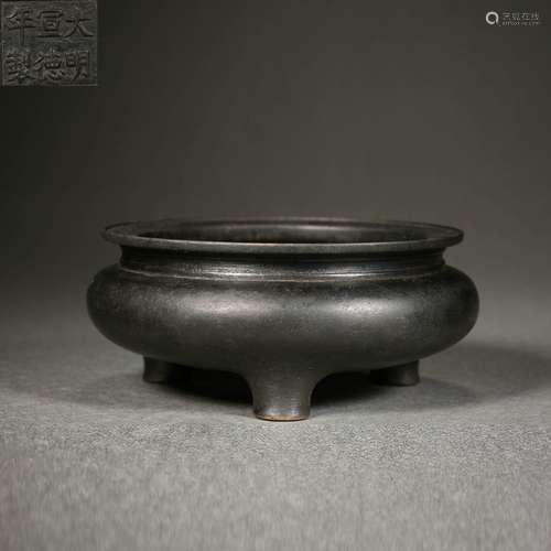 A bronze tripod censer