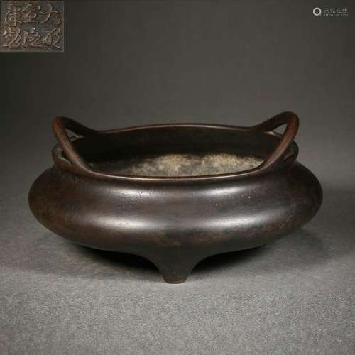 A bronze tripod censer