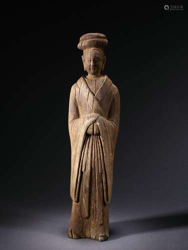 A carved wooden standing figure