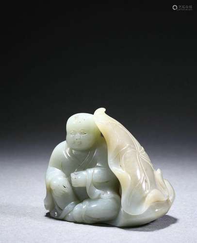 A carved jade figure with lotus