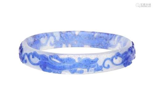 A CHINESE BLUE-OVERLAY BEIJING GLASS 'CHILONG' BANGL...