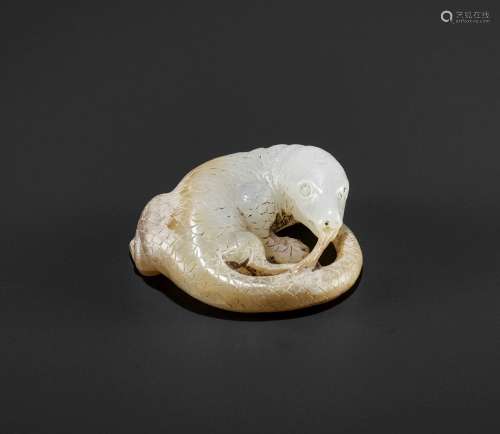 AN ARCHAISTIC WHITE AND RUSSET JADE FIGURE OF A LIZARD, QING