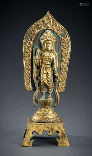 AN ARCHAISTIC FIRE-GILT COPPER REPOUSSÉ FIGURE OF A BODHISAT...