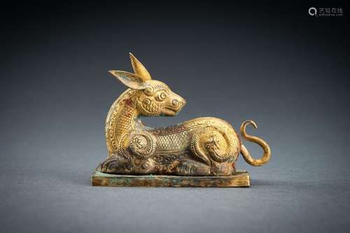 AN ARCHAISTIC FIRE-GILT COPPER REPOUSSÉ FIGURE OF A DEER