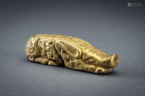 AN ARCHAISTIC FIRE-GILT COPPER REPOUSSÉ FIGURE OF A RECLININ...