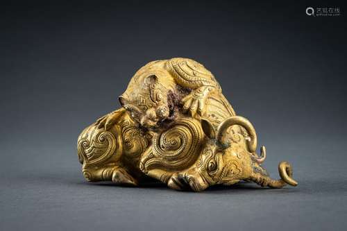 AN ARCHAISTIC FIRE-GILT COPPER REPOUSSÉ FIGURE OF A BULL AND...