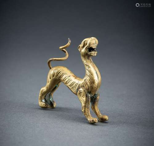 AN ARCHAISTIC FIRE-GILT COPPER REPOUSSÉ FIGURE OF A TIGER