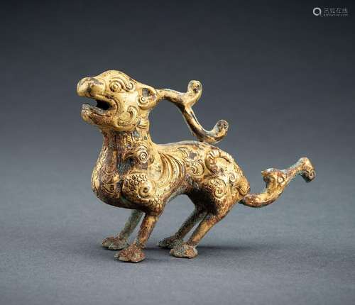 AN ARCHAISTIC FIRE-GILT COPPER REPOUSSÉ FIGURE OF A BIXIE