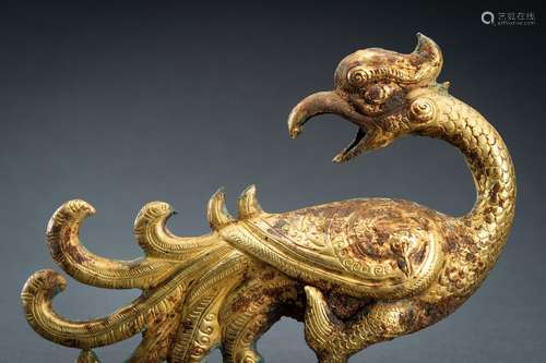 AN ARCHAISTIC FIRE-GILT COPPER REPOUSSÉ FIGURE OF A PHOENIX