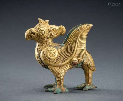 AN ARCHAISTIC FIRE-GILT COPPER REPOUSSÉ FIGURE OF A MYTHICAL...