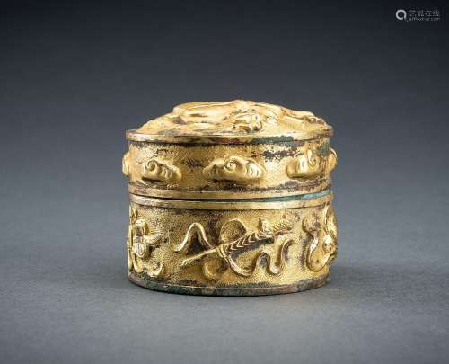 AN ARCHAISTIC FIRE-GILT COPPER REPOUSSÉ BOX WITH BUDDHIST SY...