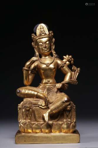 A gilt-bronze figure of Avalokitesvara holding a lotus, Qing...