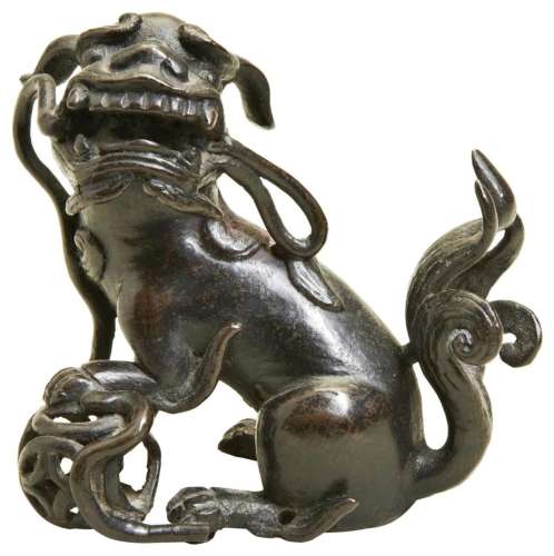 A SMALL BRONZE BUDDHIST LION LATE MING DYNASTY possibly a fi...