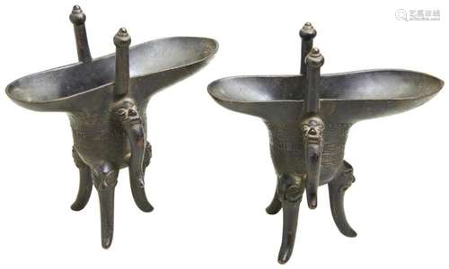 A PAIR OF BRONZE ARCHAISTIC RITUAL TRIPOD WINE VESSELS, JUE ...