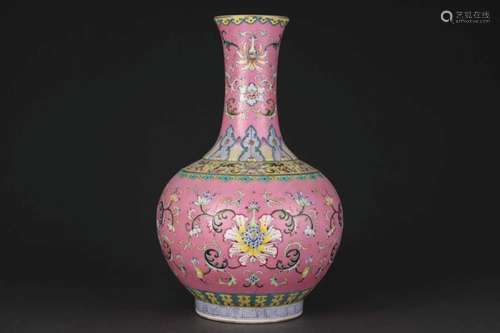 A RUBY-GROUND FAMILLE ROSE BOTTLE VASE.MARK OF QIANLONG