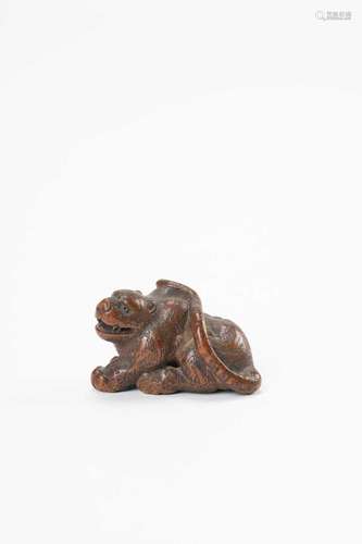 A JAPANESE WOOD NETSUKE OF A TIGER EDO PERIOD, 18TH/19TH CEN...