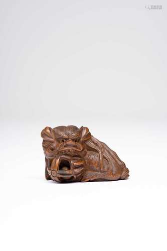 A JAPANESE BOXWOOD NETSUKE OF A SHISHI MEIJI ERA, 19TH CENTU...