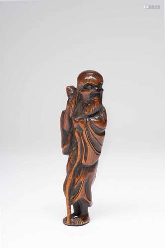 A TALL JAPANESE WOOD NETSUKE OF A SENNIN EDO PERIOD, 18TH CE...